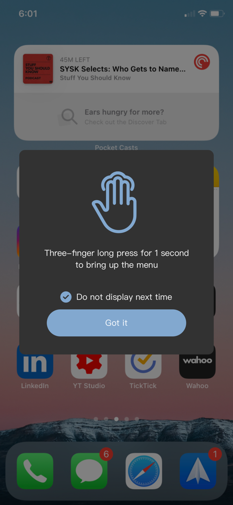 Instructional pop-up on an iPhone explaining how to use a three-finger long press to open the Magic Switch menu.