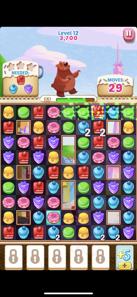 Gameplay screenshot of Cupcake Mania showing a match three puzzle board with colorful pastries and Bruno the Bear