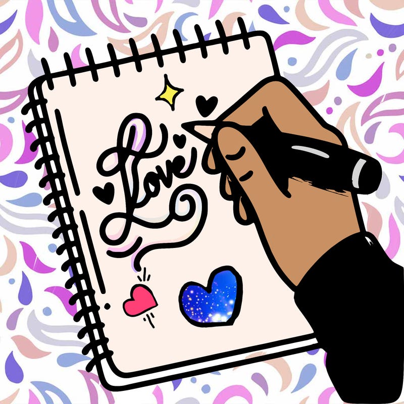 a hand writing “love” in calligraphy on a notebook