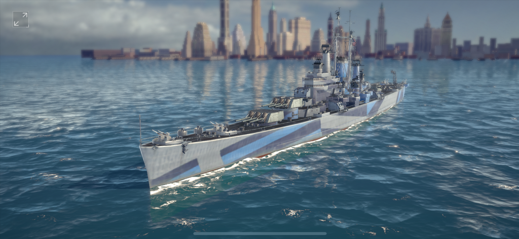 Armada: Warships Legends - A detailed historical warship with blue camouflage sailing on the ocean with a city skyline in the background
