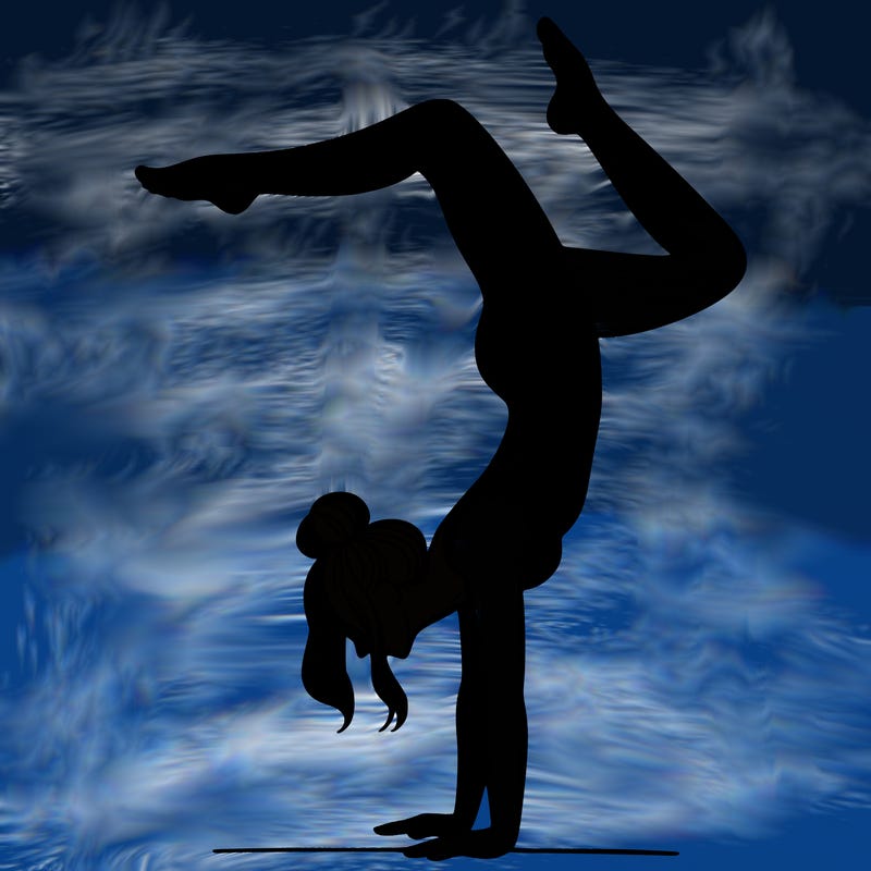 a woman doing a handstand