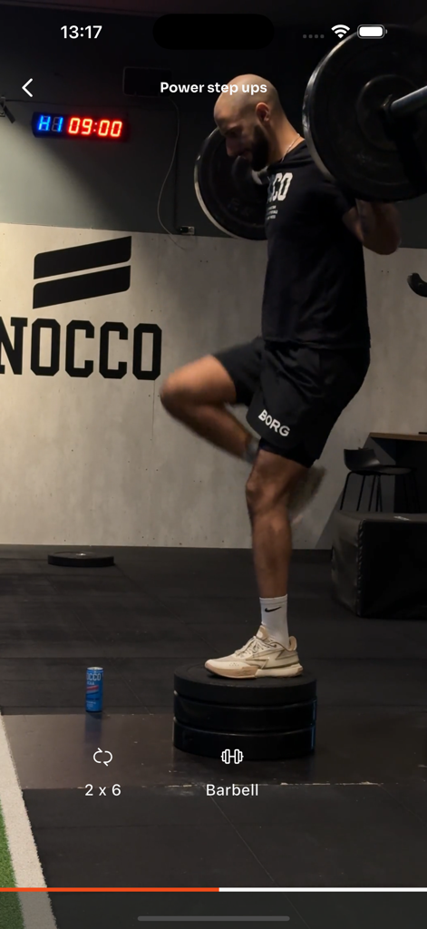 Amir Performance - Athlete performing power step ups with a barbell for basketball conditioning