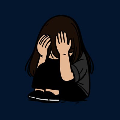 girl sitting down covering her head