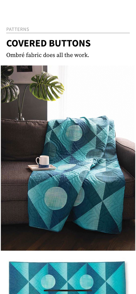 McCall's Quilting Magazine - A blue and teal geometric quilt draped over a brown sofa showcasing the Covered Buttons pattern.