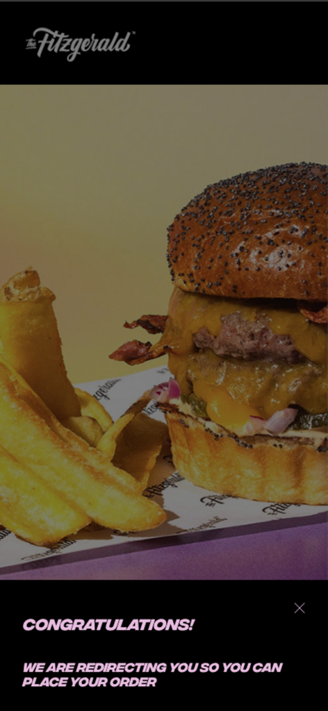 The Fitzgerald App - A close-up of a gourmet double cheeseburger and fries on The Fitzgerald App order redirection screen