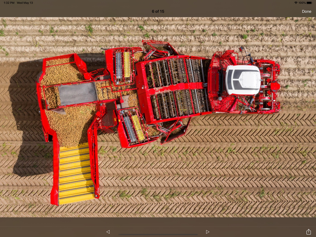 GRIMME - Top down aerial view of a red GRIMME potato harvester operating in a field
