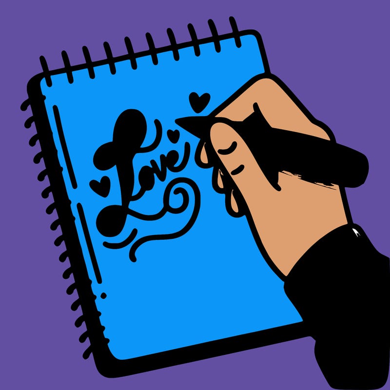 a hand writing “love” in calligraphy on a notebook