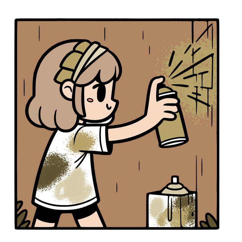 a girl spray panting a wall