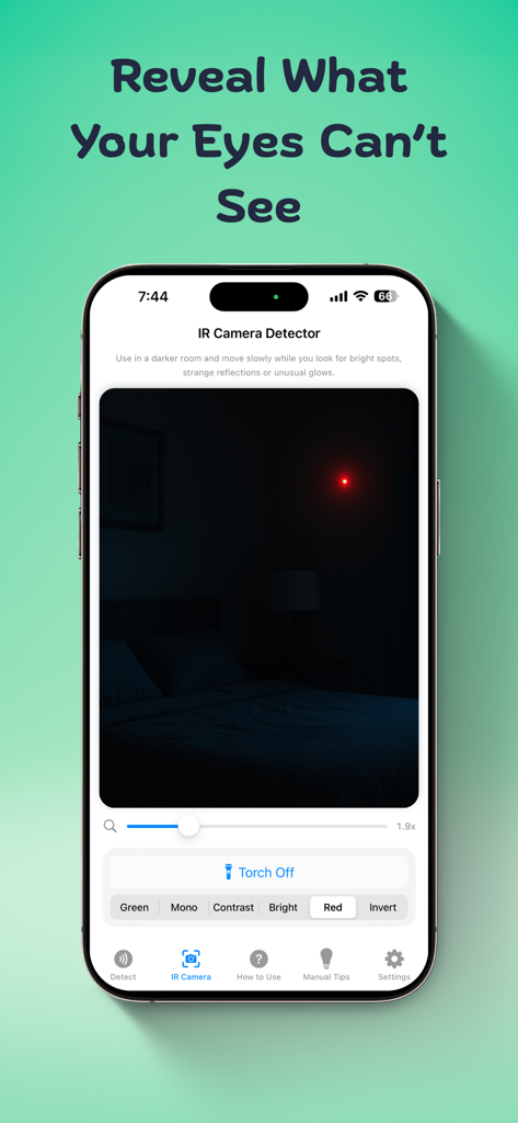 Smartphone screen displaying an infrared camera detector app identifying a hidden device in a dark room