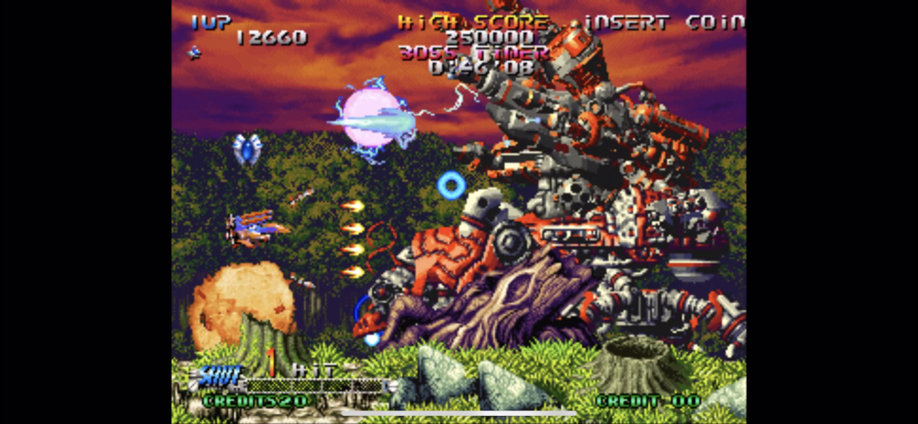 Gameplay de BLAZING STAR montrant un vaisseau spatial attaquant un boss mécanique imposant dans un niveau forestier