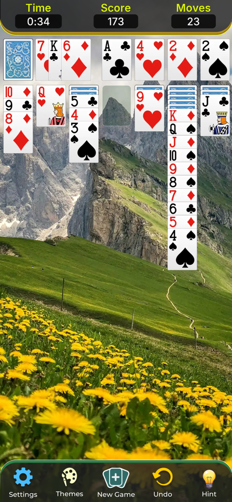 Solitaire Classic Game. - Classic Klondike solitaire gameplay featuring a scenic mountain landscape background with yellow flowers.