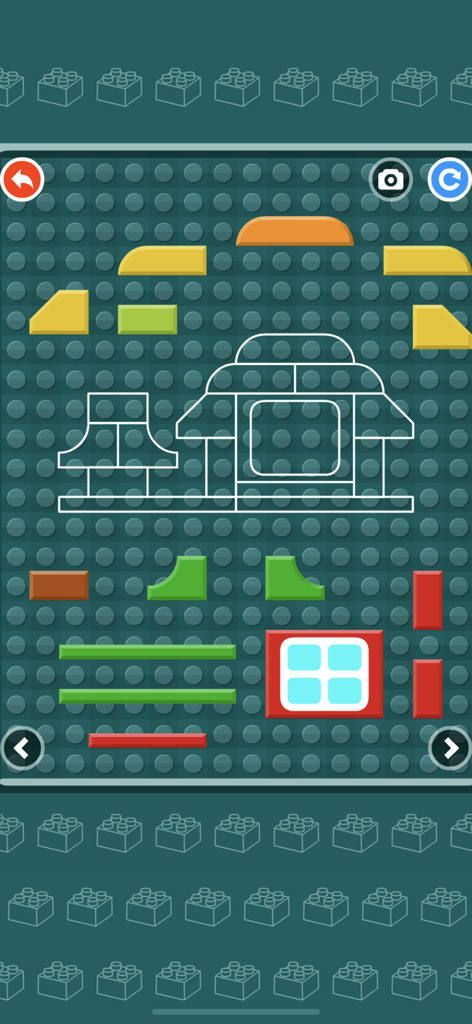 Building Blocks Puzzle Game - A digital puzzle screen where toddlers drag and drop colorful blocks to complete a house outline on a green baseplate.