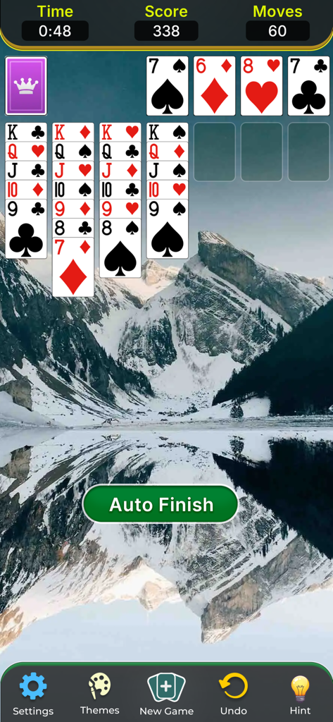 Solitaire Classic Game. - Klondike Solitaire gameplay with a scenic mountain lake background and auto-finish button.
