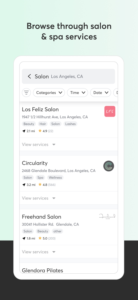 Mindbody mobile app interface displaying local salon and spa business listings with ratings and distances