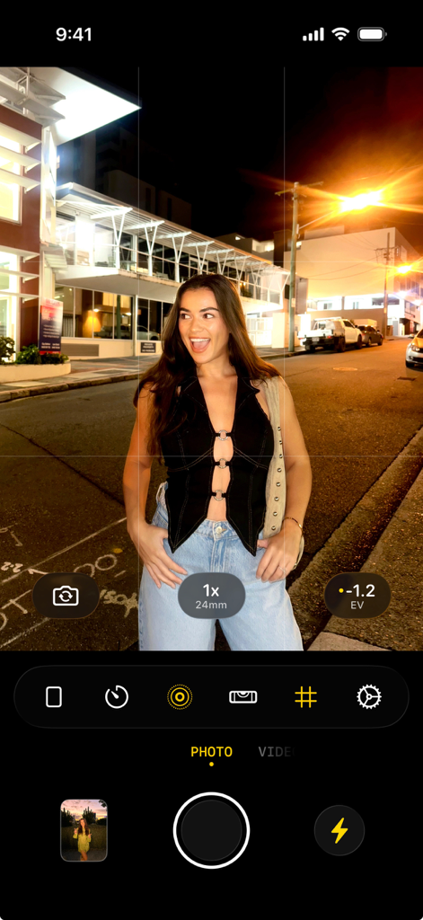 User interface of the flag7x camera app featuring a night flash photo of a woman in an urban setting