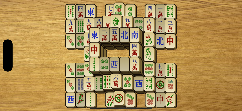 Classic mahjong solitaire board with large tiles on a wooden background