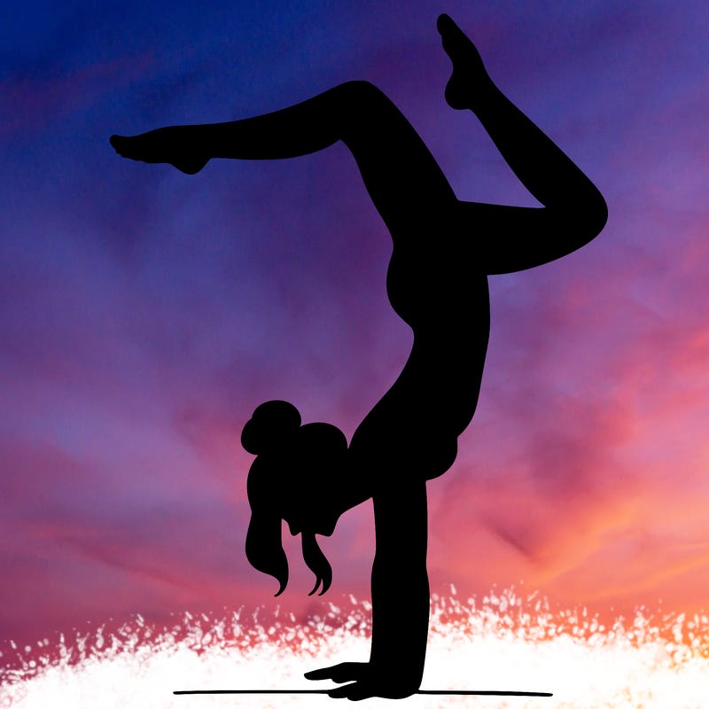 a woman doing a handstand