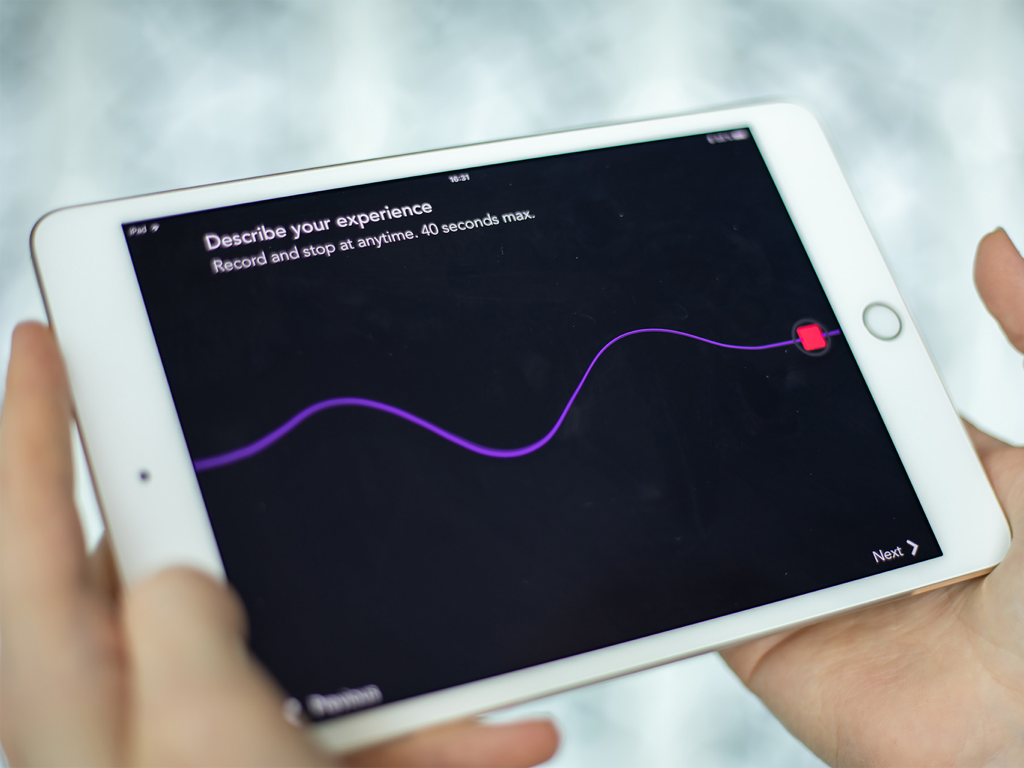 A tablet showing a voice recording interface for museum visitors to share their experiences