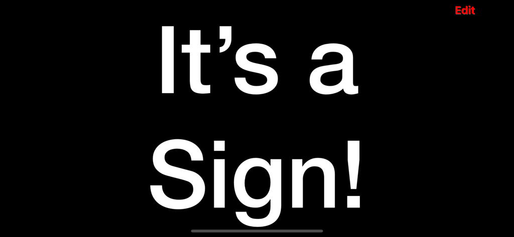 A professional digital sign with high contrast white text on a black background showing the message It's a Sign! inside the Limosign app.