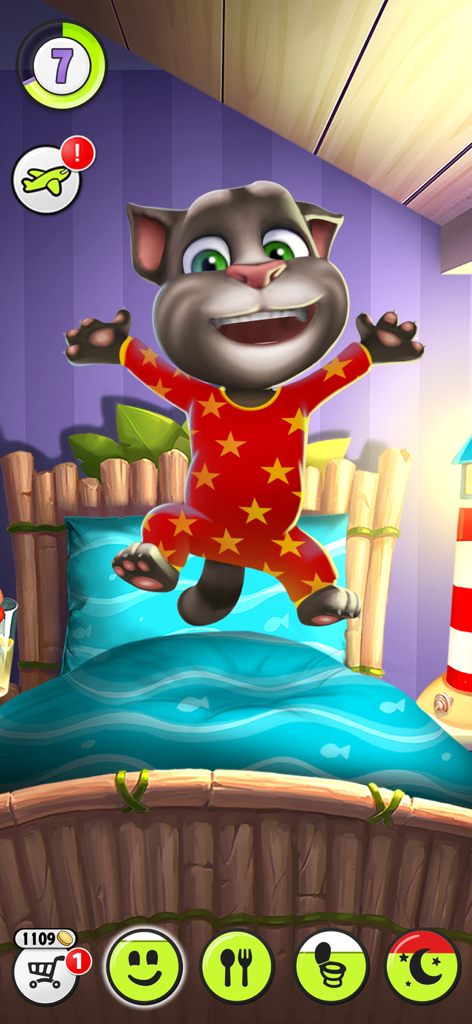 Gato Talking Tom pulando em sua cama vestindo pijamas vermelhos com estrelas amarelas