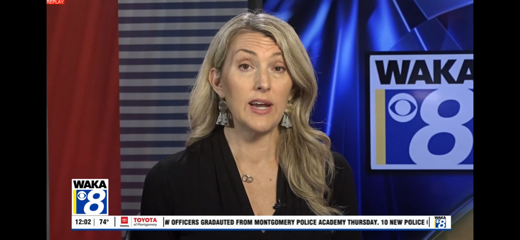 WAKA News - A female news anchor presenting a live local news segment for WAKA News 8.