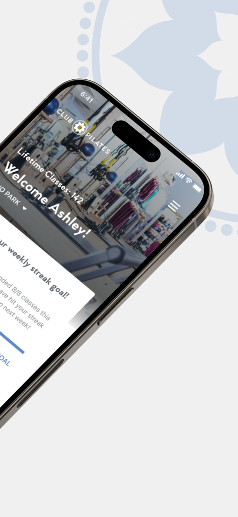 Club Pilates app personalized welcome screen showing lifetime classes and weekly streak goals on a smartphone