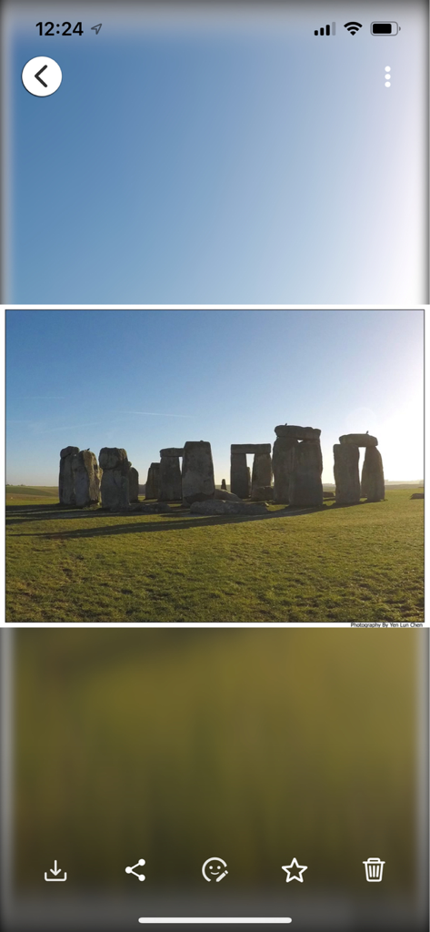 QuMagie app photo viewer showing a landscape picture of Stonehenge with action icons for downloading sharing and facial recognition.