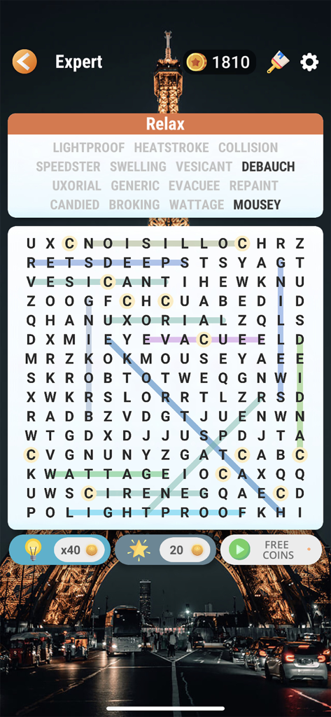Word Search - Find Hidden Word - Interfaz del juego de puzle de sopa de letras en dificultad experta con un tema de fondo de la Torre Eiffel y palabras coloridas resaltadas.
