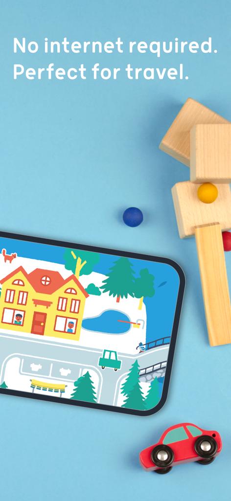 Pok Pok | Montessori Preschool - Smartphone screen showing a town scene in the Pok Pok app next to wooden blocks and a toy car