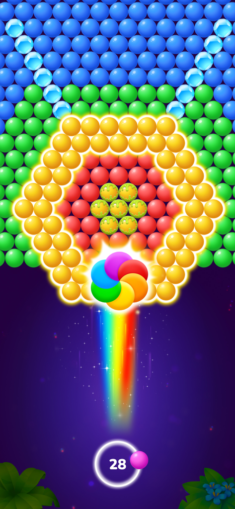 Una bola arcoíris apuntando a burbujas hexagonales de colores en un juego de disparar burbujas