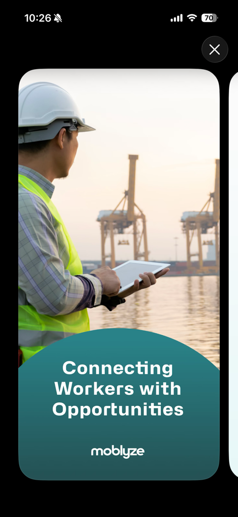An energy professional in a hard hat and safety vest using a tablet at an industrial port with the caption Connecting Workers with Opportunities.