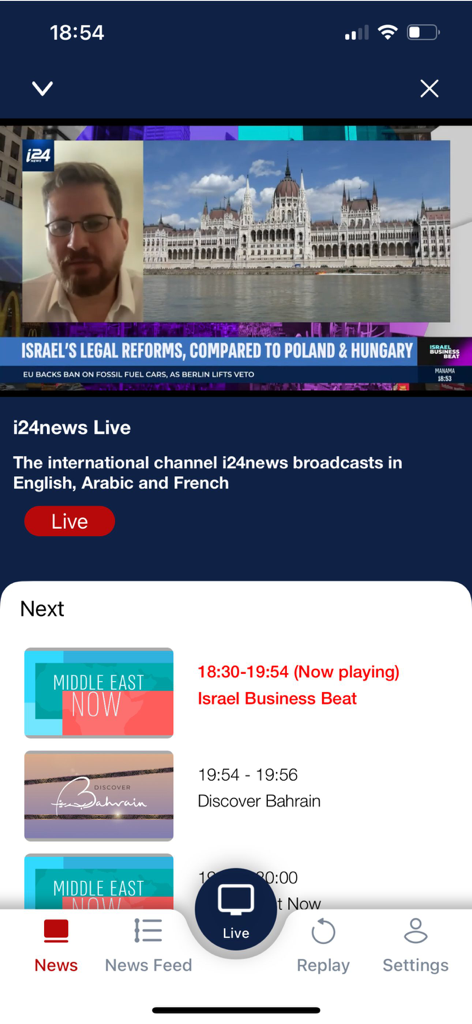 Interface of the i24NEWS mobile app featuring a live international news broadcast and program schedule