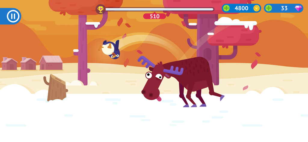 Bouncemasters gameplay showing a penguin flying through the air over a moose in a snowy landscape.