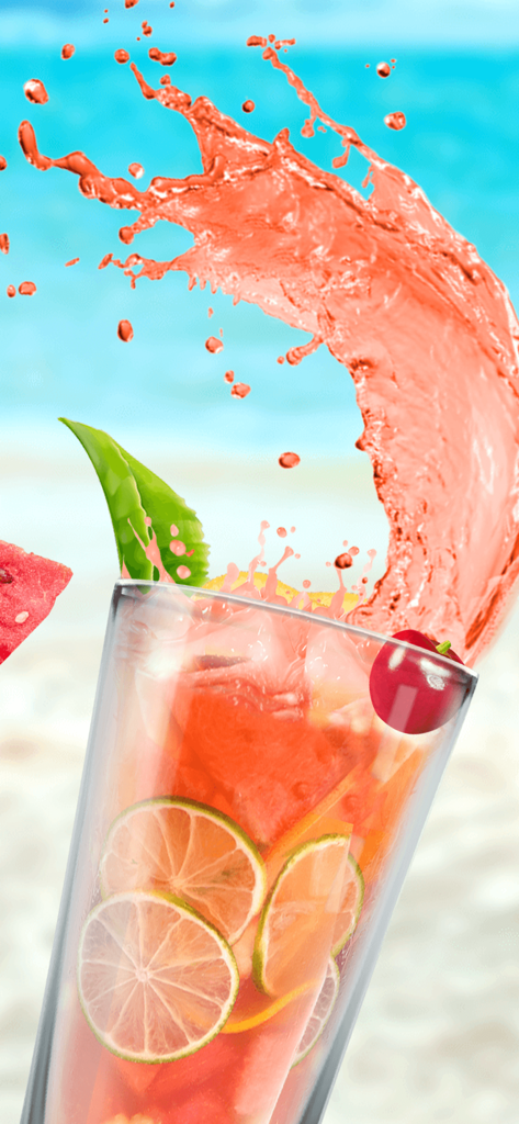 Virtual pink fruit drink with lime slices and watermelon splash on a beach