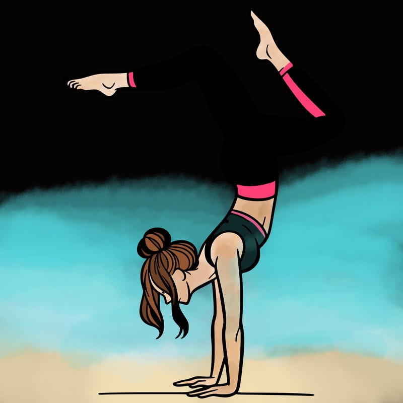 a woman doing a handstand