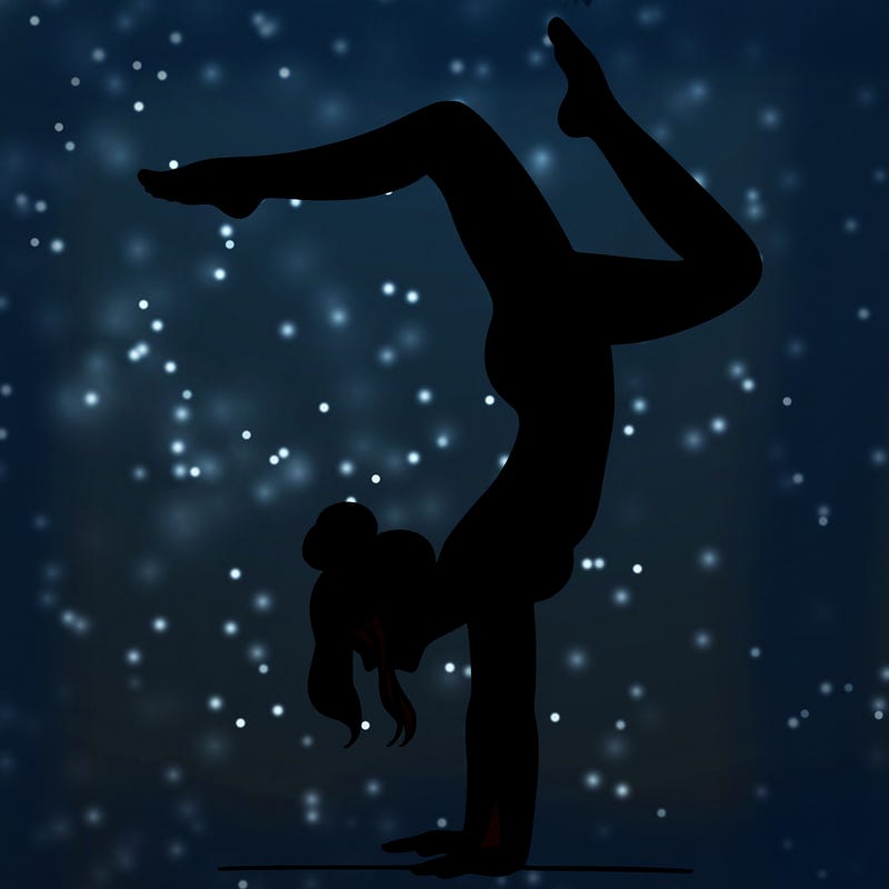 a woman doing a handstand