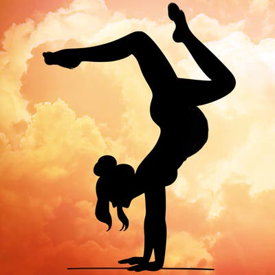 a woman doing a handstand