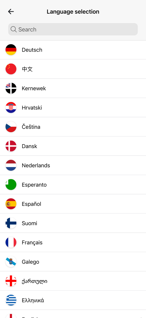 Language selection screen in the Curiocity app showing a list of supported international languages and flags.