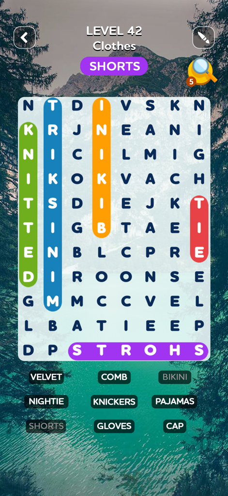Word Search Quest Puzzles - Word search puzzle gameplay showing the clothes category with a scenic mountain background