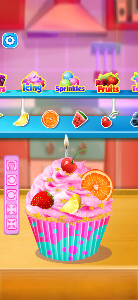 My LunchBox - Cooking Game - A pink frosted cupcake being decorated with fresh fruit and gold stars in the My LunchBox cooking game
