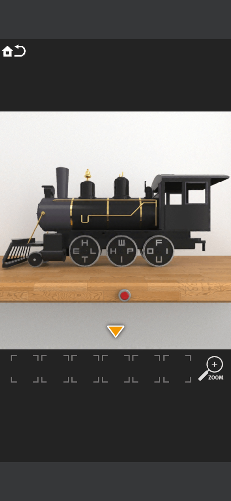 A black toy steam locomotive with letters on its wheels used as a puzzle in a room escape game.