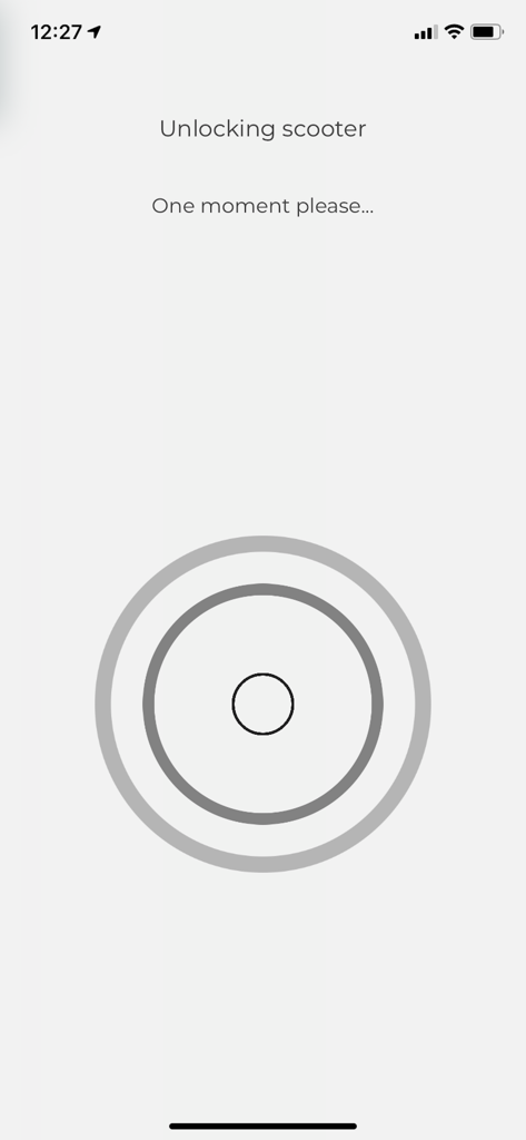 Movatic app screen showing the process of unlocking a scooter with a status message and progress icon