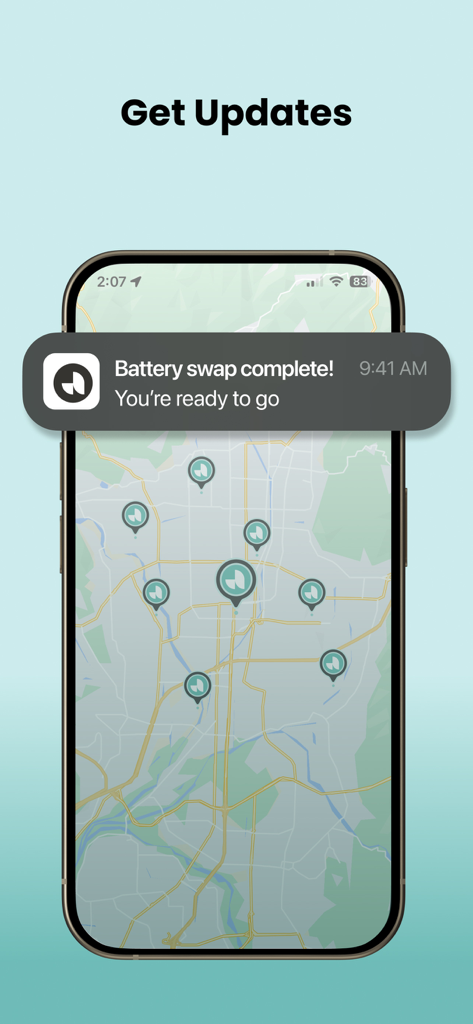 Ample App - Ample App mobile screen showing a battery swap complete notification over an urban map with station locations.