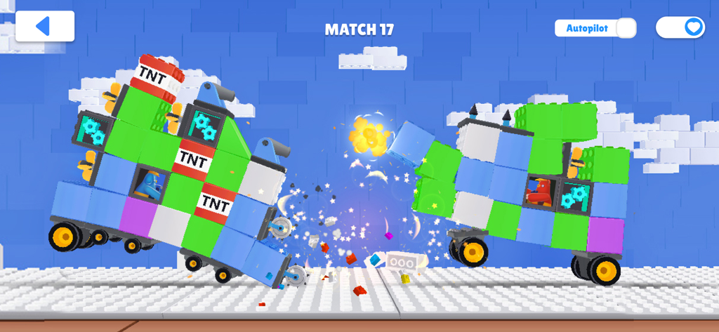 Two custom brick-built toy tanks crashing into each other in a battle arena with a TNT explosion