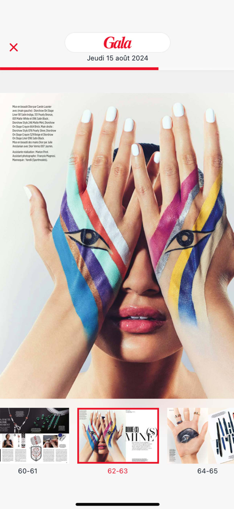 Digital magazine spread in the Gala app featuring a high-fashion beauty editorial with artistic hand painting