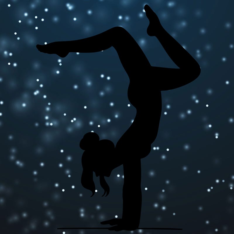 a woman doing a handstand