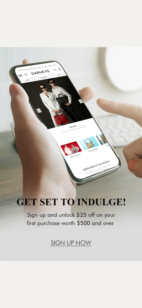 Darveys Luxury Shopping - A person holding a phone showing the Darveys luxury shopping app with a signup discount offer