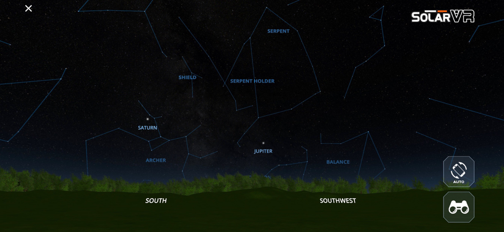 Solar System Scope VR - A view of the virtual night sky in the Solar System Scope VR app showing labeled constellations and planets like Saturn and Jupiter over a tree line