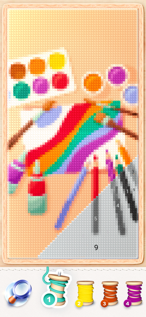 Digital cross-stitch interface showing a pixel art pattern of art supplies being colored by number with thread spools.