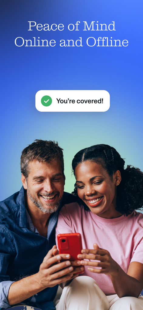 Smiling couple looking at a smartphone with a security status message